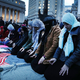 Muslim women pray before a protest in lower Manhattan against the policies of President Donald Trump on February 1, 2017 in New York City. Photo: Getty